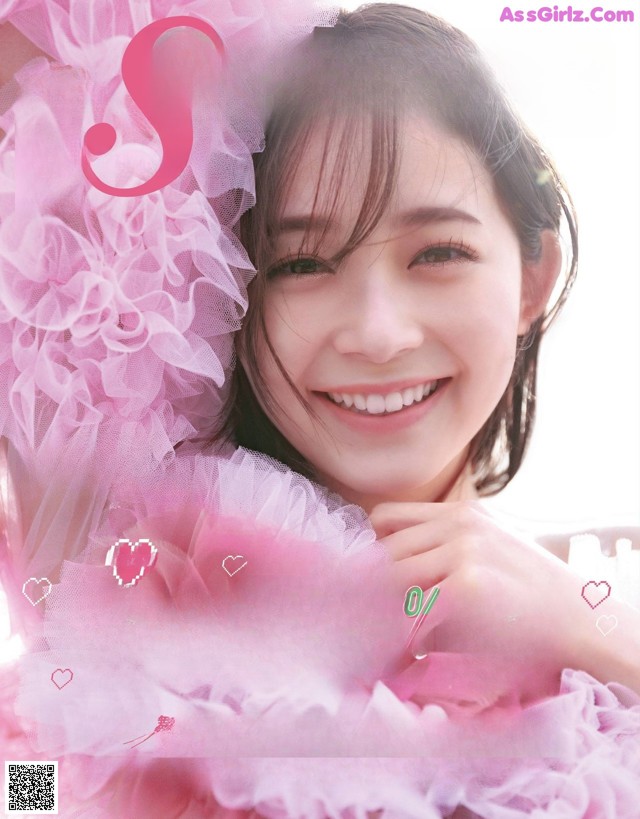 A magazine with a picture of a woman in a pink dress.