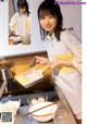 A woman in an apron preparing food in a kitchen.