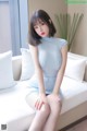 a woman sitting on top of a white couch