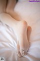 A close up of a woman's legs on a bed.